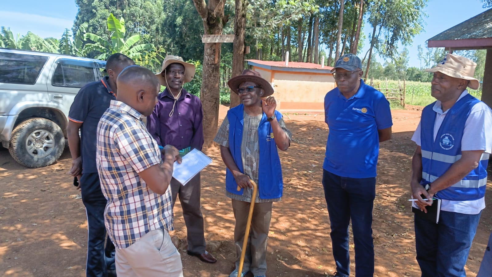 Rotary team and NVCBO staff in discussion during a site visit