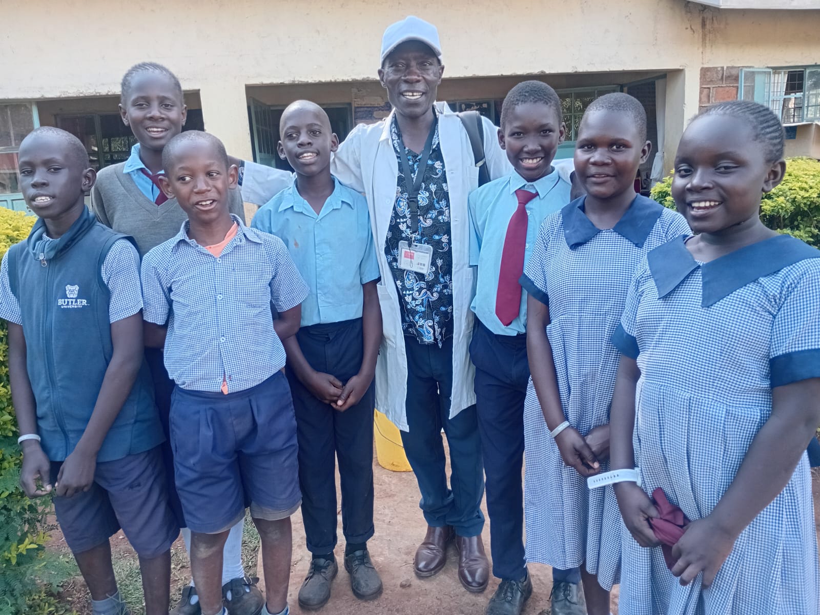 Schoolchildren with a staff member in uniform